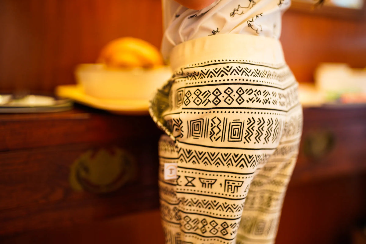 Child wearing the KendiKids Asili Joggers — mud cloth geometric print on cream