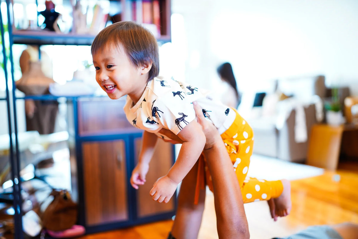 Child wearing the KendiKids Baraka Joggers — cowrie shell print on mustard
