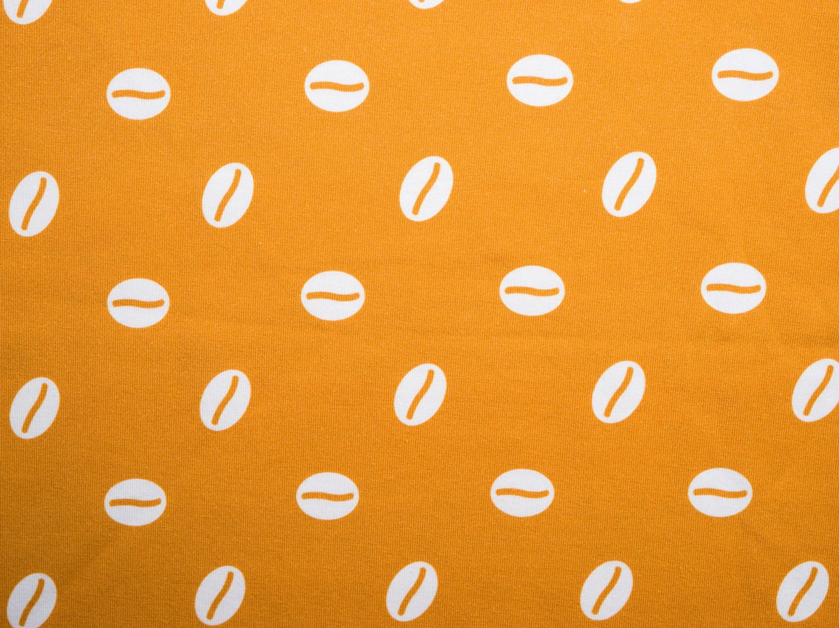 Baraka print detail — cowrie shell print in white on golden mustard