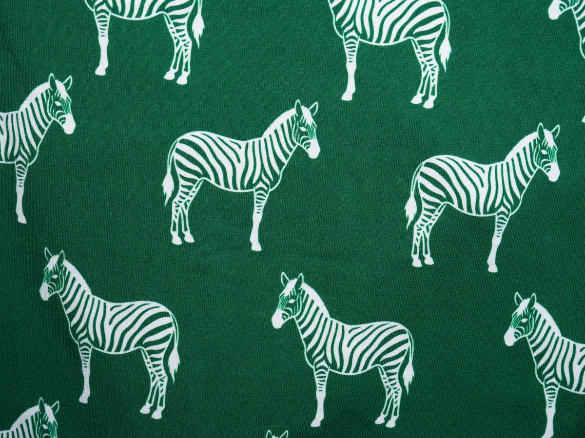 Ndoto print detail — zebra print in cream on forest green