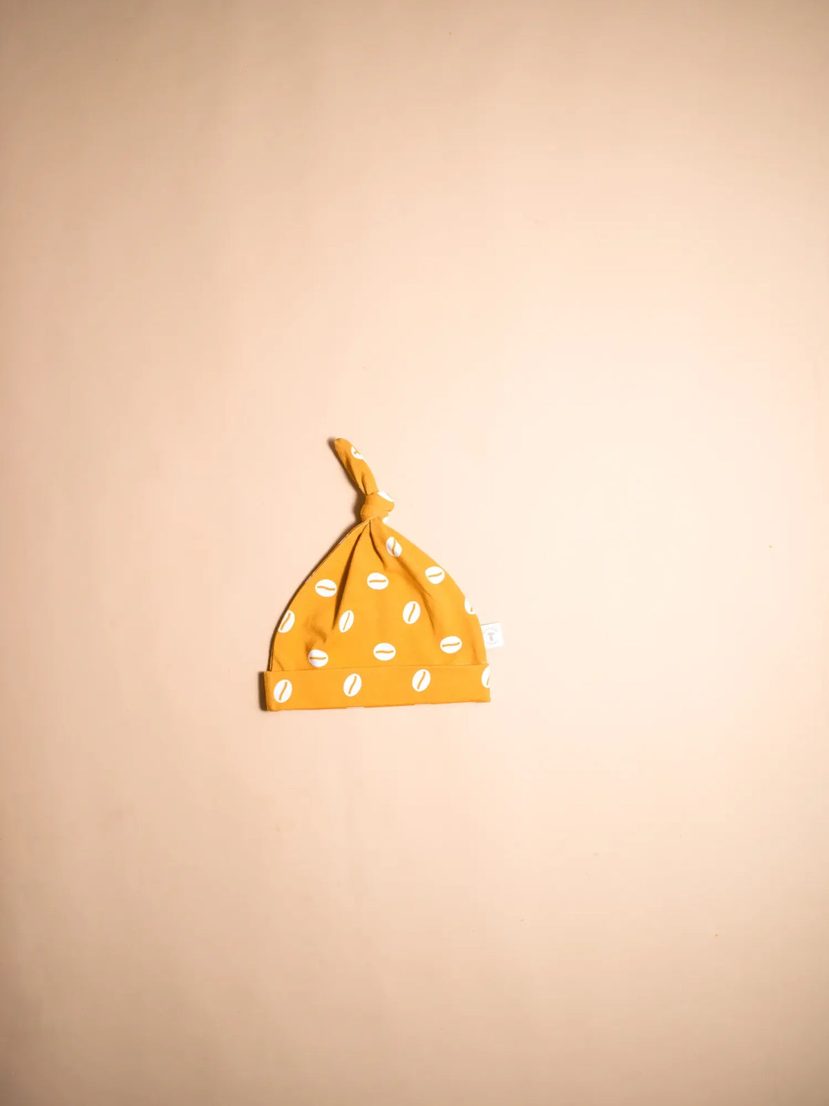 KendiKids Baraka Knot Hat — cowrie shell print in white on golden mustard