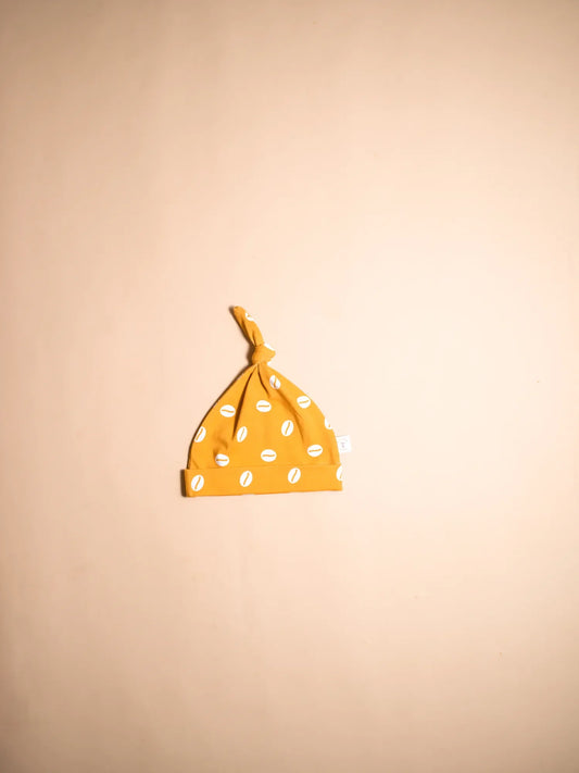 KendiKids Baraka Knot Hat — cowrie shell print in white on golden mustard
