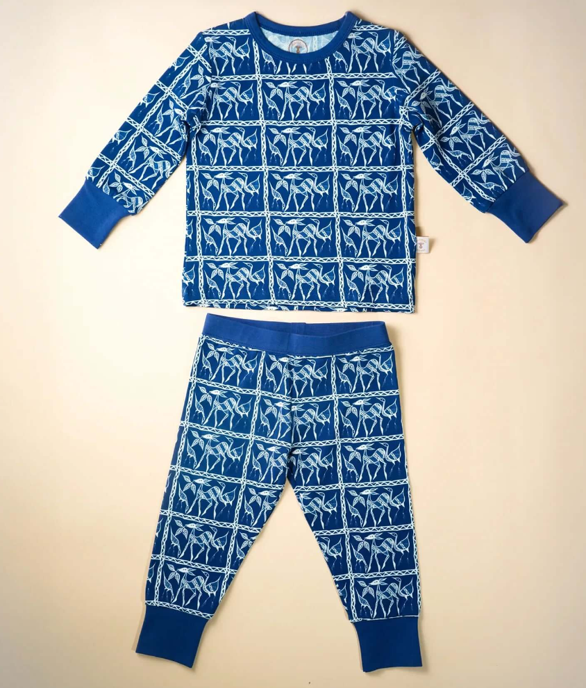 Blue pajama set with white patterns on a beige background