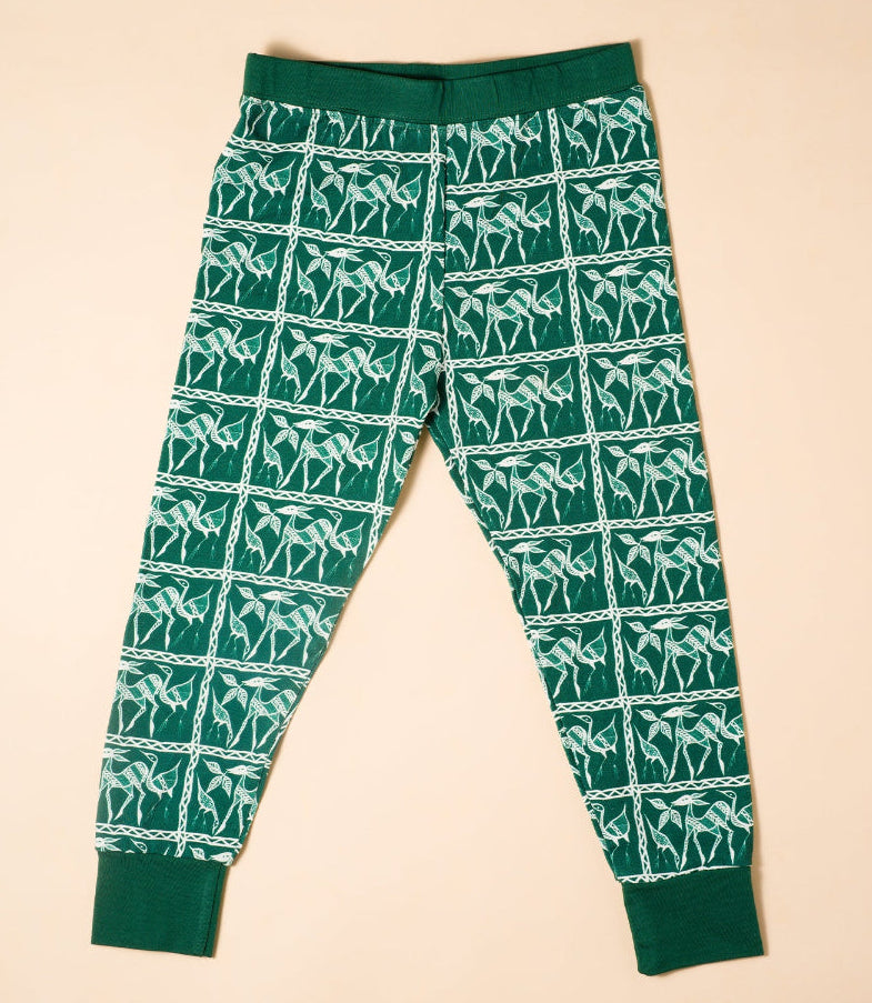 Green jogger pants with white pattern on a beige background