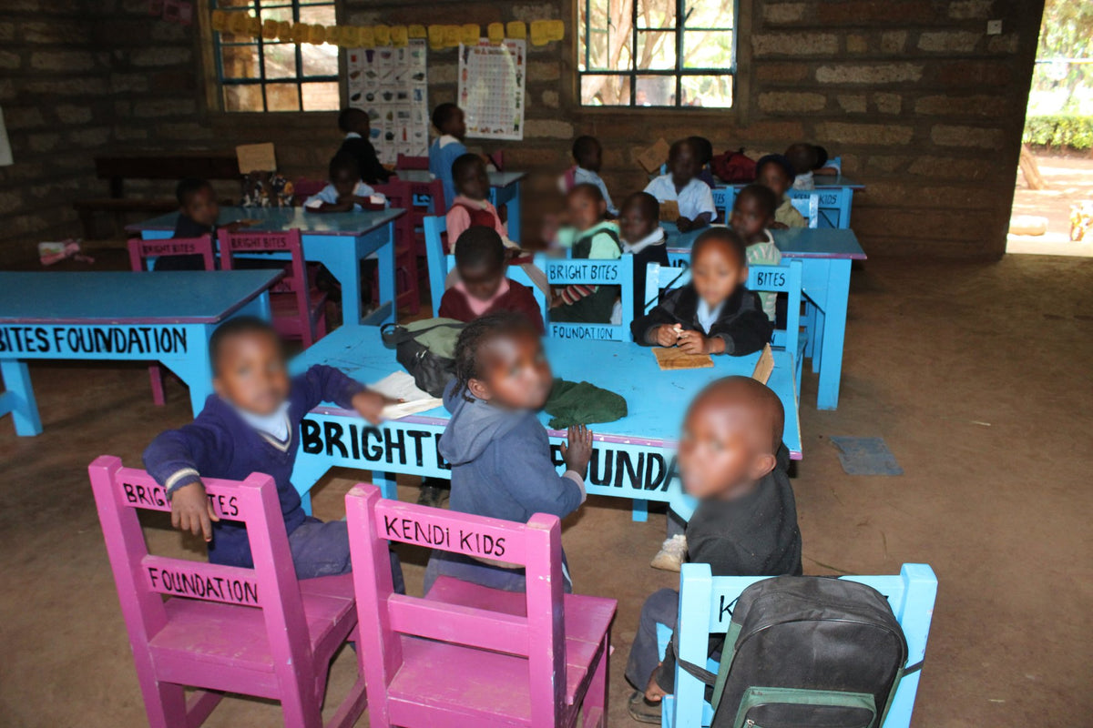 Good Shepherd children at the desks and chairs provided by KendiKids, painted with Bright Bites Foundation and Kendi Kids