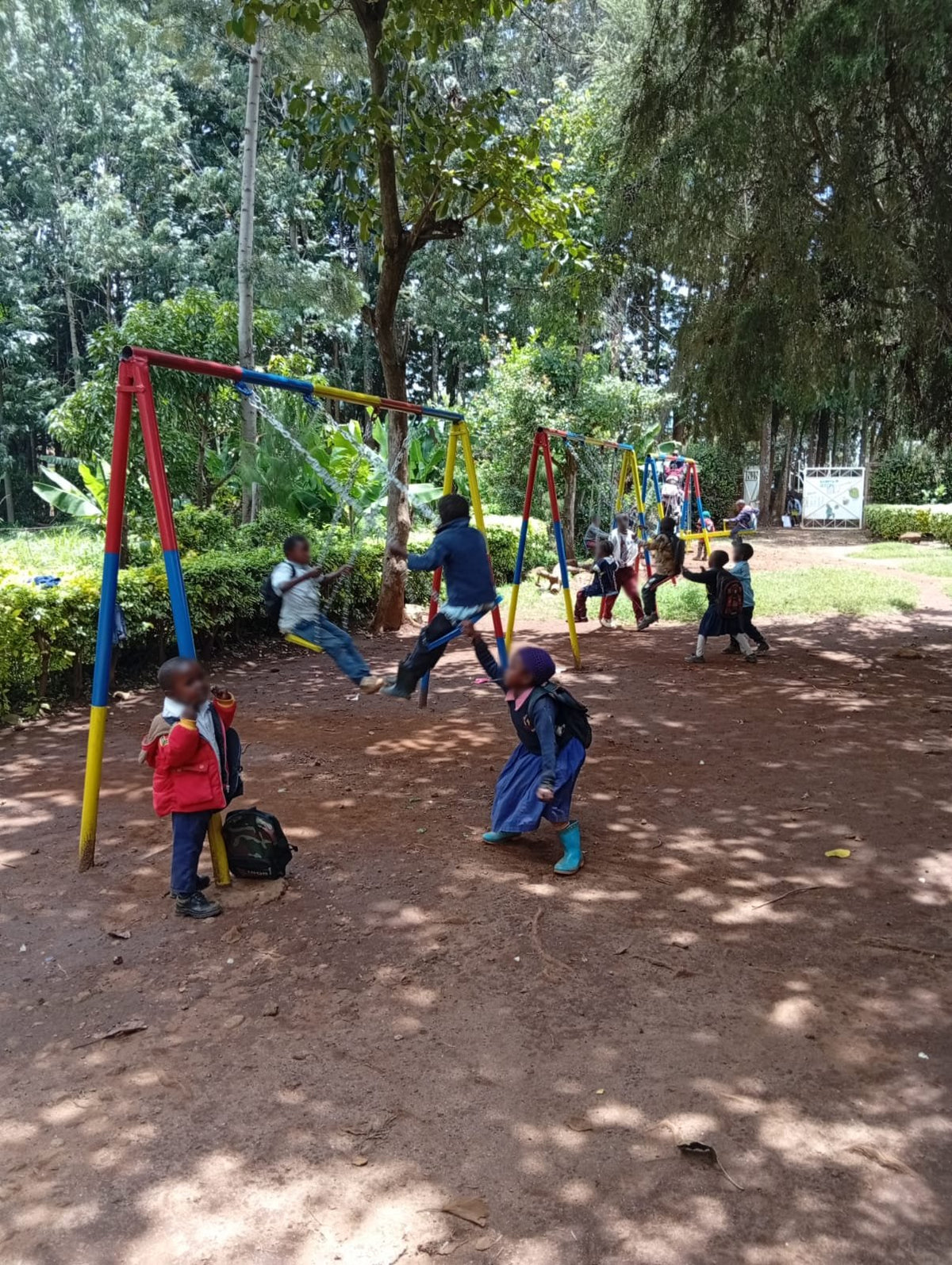 Children on the swings and seesaw KendiKids provided for the Good Shepherd playground in Meru