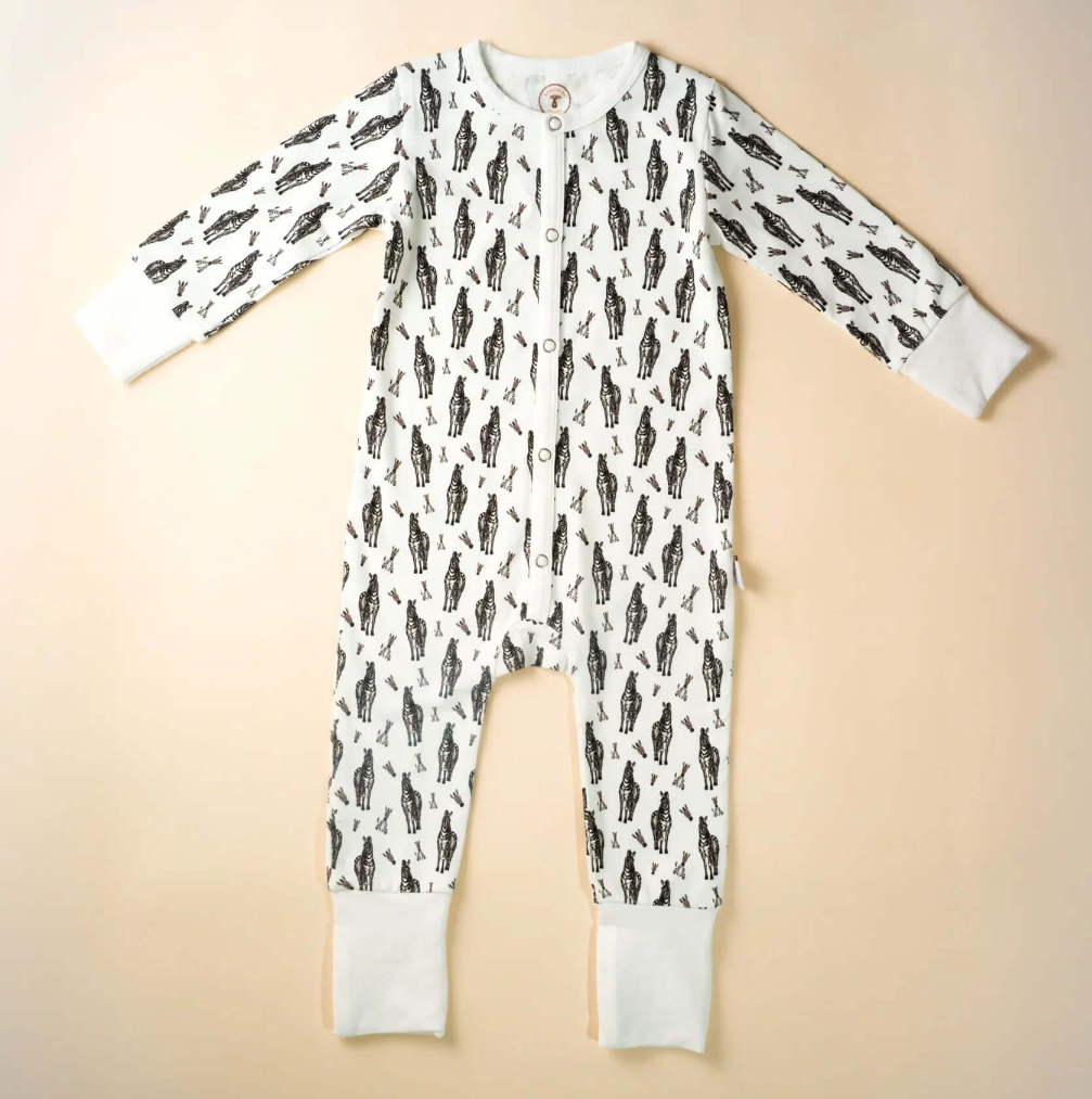 Baby onesie , romper with zebra  pattern on a beige background